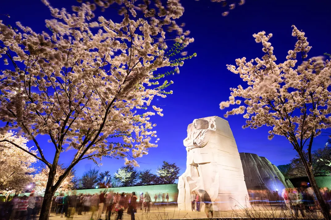 Tourists gather under the Martin Luther King, Jr. Memorial in West Potomac Park.