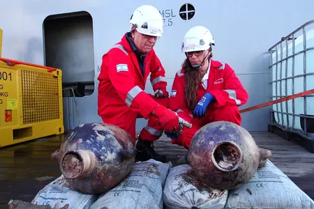 Jacob Sharvit and Karnit Bahartan examine two amphorae recovered from the world's oldest-known deep-sea wreck.