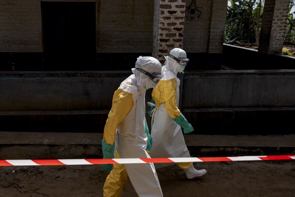 two people in full protective equipment walking on the street