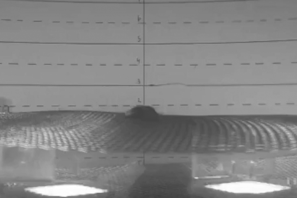 An video shows two microflyers levitating in a vacuum chamber