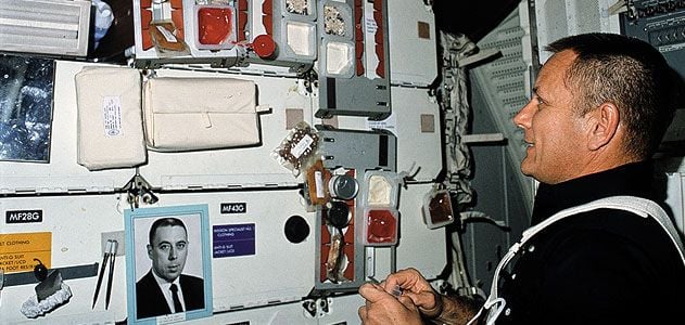 In a joking nod to George Abbey's power over manned spaceflight, astronauts (like STS-5's Bob Overmyer) sometimes carried his photo into orbit.