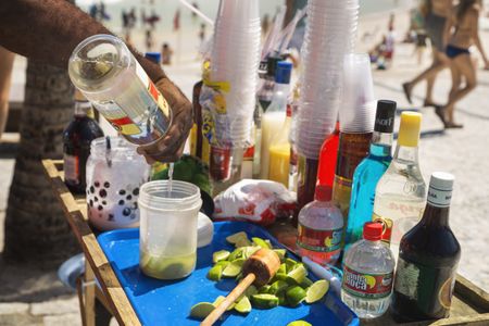 Mixing caipirinhas, the popular Brazilian cocktail made with cachaça, on Ipanema Beach.
