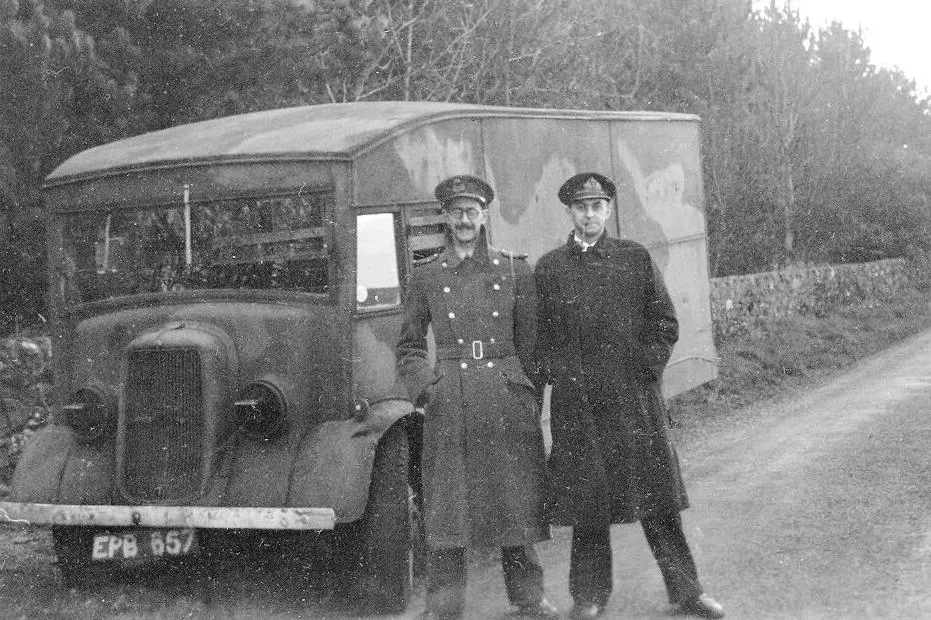 British intelligence officers involved in the planning of Operation Mincemeat pose in front of the vehicle that transported the body of Glyndwr Michael for pickup by submarine.