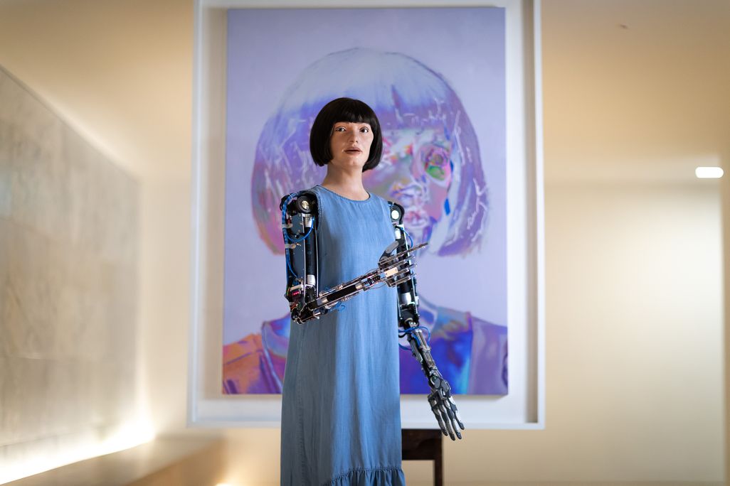Ai-Da in front of self-portrait