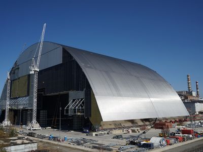 Builders work on the Chernobyl New Safe Confinement arch in April 2016. Once complete, the massive arch will be slid over the reactor's current concrete sarcophagus. 