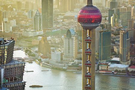 The view from 87 stories up includes the Oriental Pearl TV tower, center, the terraces of the Jin Mao Tower, left, and a metroplex growing to fit 23 million people.