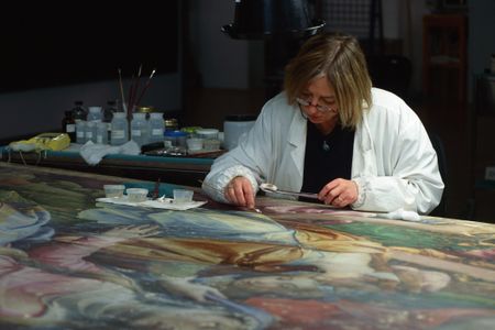 An expert at work on a painting at the Opificio Delle Pietre Dure