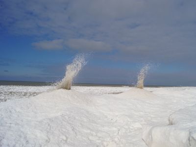 On Sunday, a National Weather Service employee snapped a photo of two ice volcanoes erupting on the shores of Lake Michigan.