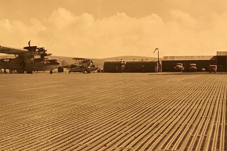 Airfields in Alaska's Aleutian chain (pictured is Tanaga) started getting steel mat runways in 1942. Marston was better than mud, but a hard landing could bounce a small fighter 30 feet, and heavy bombers made the mat ride up in waves.
