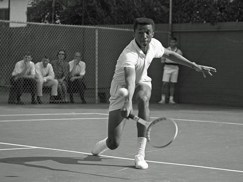 Arthur Ashe playing tennis against Dennis Ralston in 1964