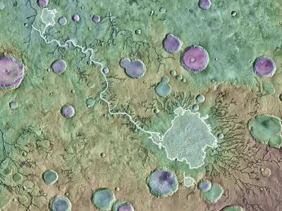 Image description via the Plantetary Science Institute: &quot;Loire Vallis (white line) is an outlet canyon that formed from the overflow of a lake in Parana Basin (outlined in white). Black lines indicate other valleys formed by processes other than lake overflows. Background is colored MOLA-derived topography over a THEMIS image mosaic. Image is approximately 650 kilometers across.&quot;