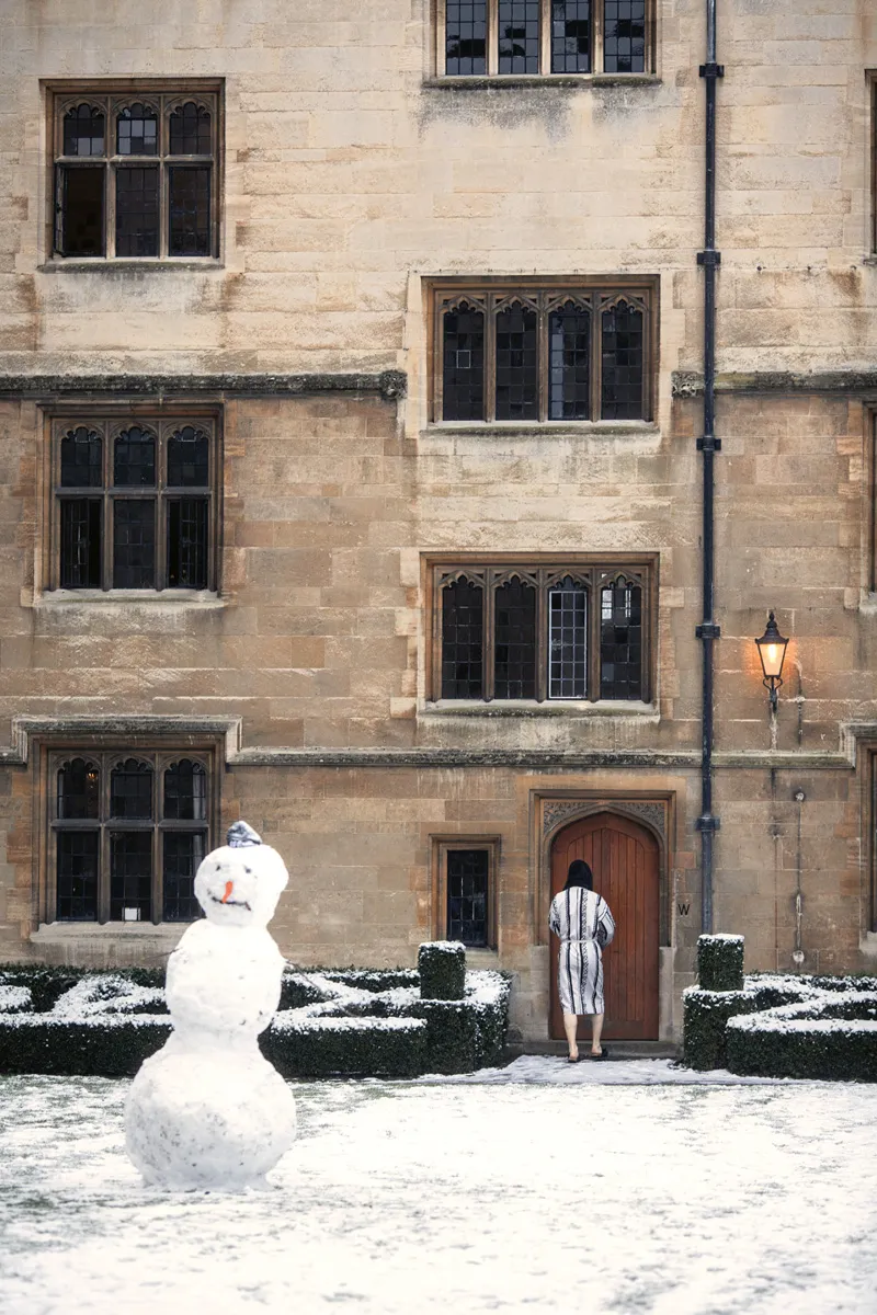 Snowman beside a building
