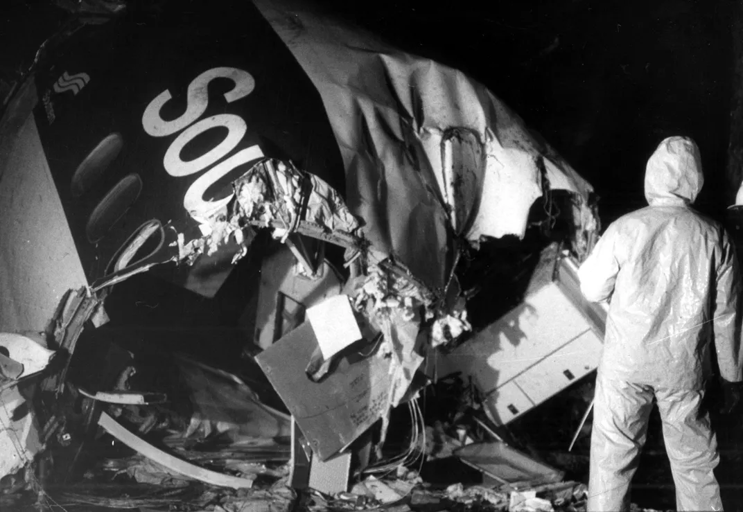 A worker searches through the wreckage