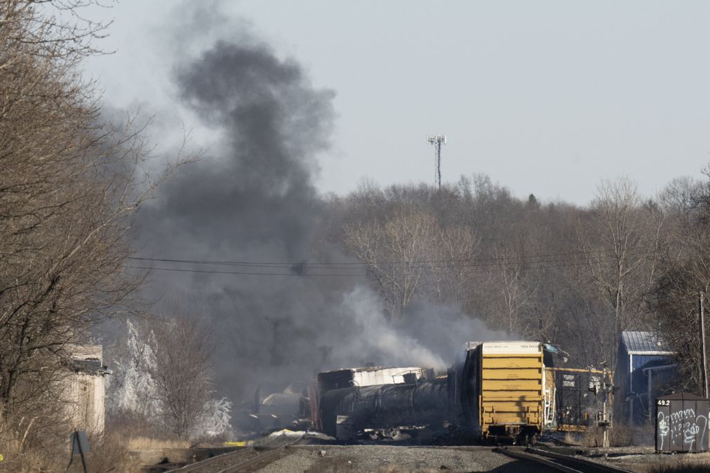 Smoke rises from derailed train cars in East Palestine, Ohio.