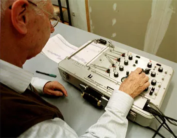A researcher tests a polygraph machine.