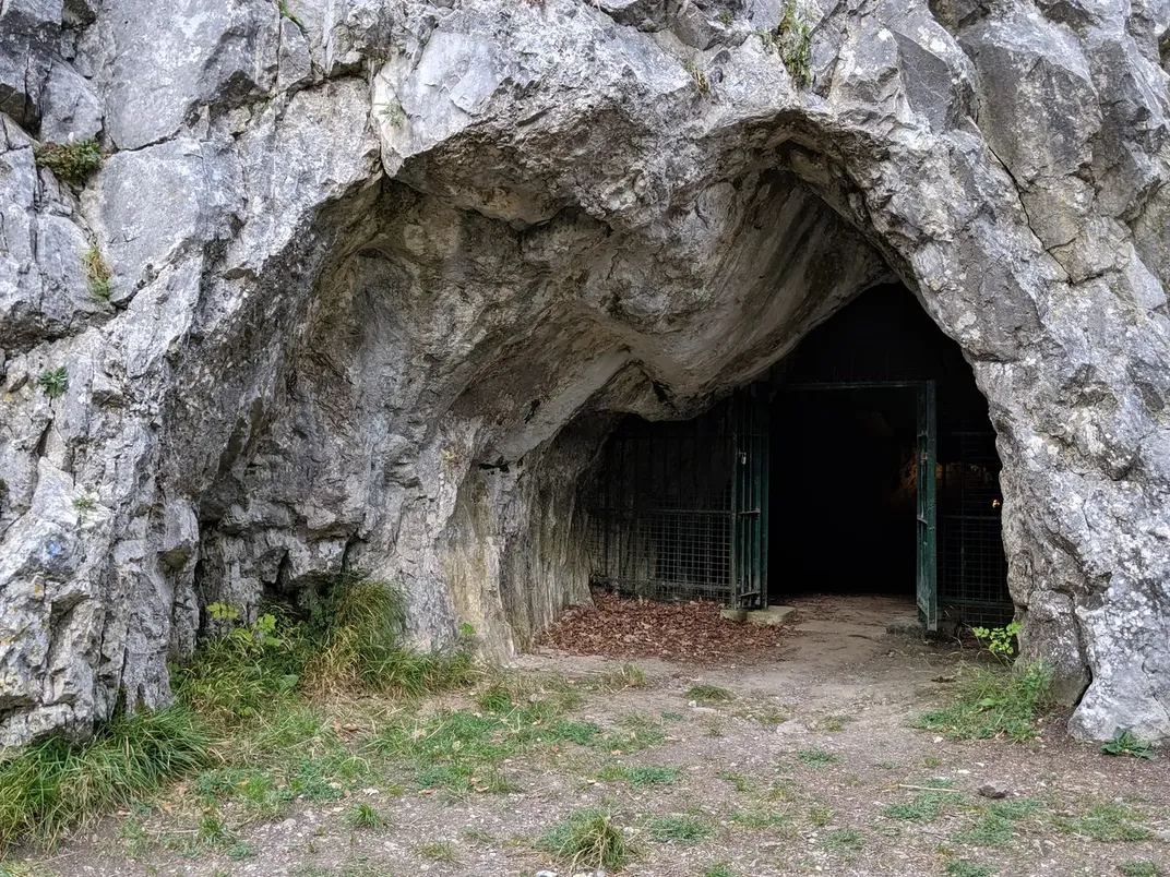The entrance to a cave with a gate over it