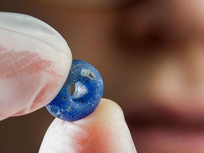 A blue bead uncovered at the Iron Age village archeological site in Norway.