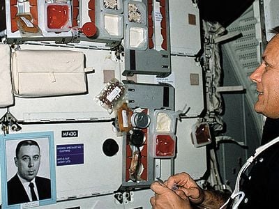In a joking nod to George Abbey's power over manned spaceflight, astronauts (like STS-5's Bob Overmyer) sometimes carried his photo into orbit.