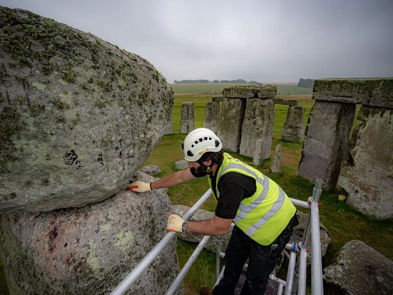 Conservator examines megalith at Stonehenge