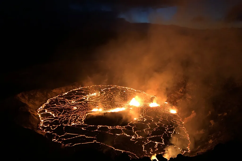 An image of the glowing red fissures inside of the Halema'uma'u Crater located on the Kīlauea volcano's summit