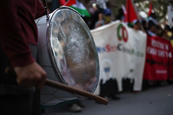 A protester holds a drum thumbnail