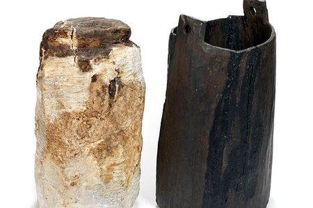 A 2,325-year-old bog butter weighing almost 30 pounds,  alongside the keg it was found in. 