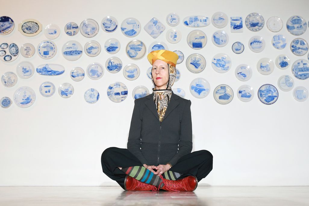 Artist Julie Green poses in front of a selection of The Last Supper ​​​​​​​plates in 2015.