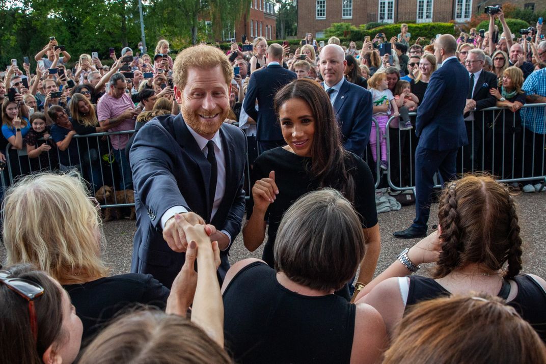 Prince Harry and Meghan, the Duke and Duchess of Sussex, greet well-wishers on the Long Walk outside Windsor Castle