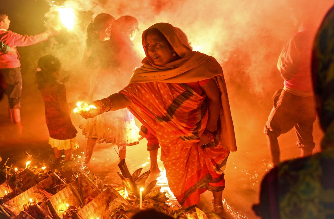 A lady is preparing lamps during Chhat festival in India. | Smithsonian ...