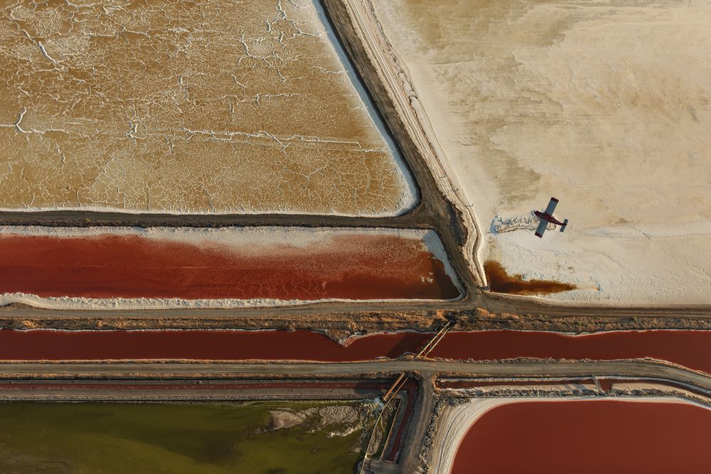 If you’ve flown into SFO, you’ve likely seen these vivid salt ponds. I’ve photographed them often—their colors and patterns shift with microorganisms and salinity. Together they yield over 500,000 tons of sea salt each year.