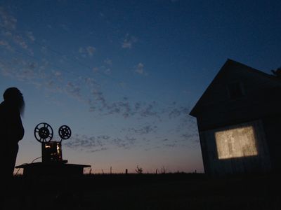  In a still from the documentary, Michael Zahs screens one of the early films against a barn in Iowa.