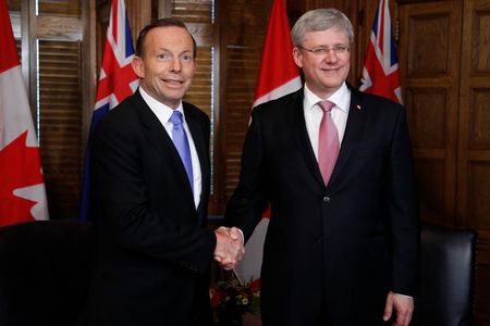 Australian Prime Minister Tony Abbott (L) with Canadian Prime Minister Stephen Harper (R) on June 9, 2014