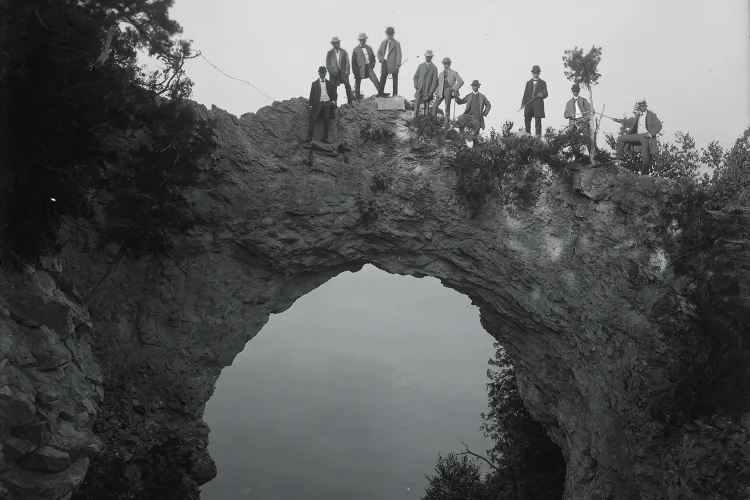 Visitors pose atop Arch Rock, a geological formation on Mackinac Island