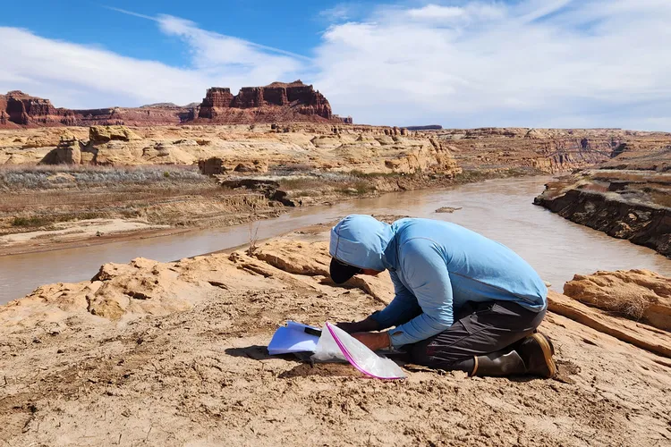Chris Benson Examines Photos of the Colorado River