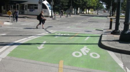 Simple but safe: An elaborately painted bike lane in Portland marks among the few places on America’s roadway system where cars are not allowed.