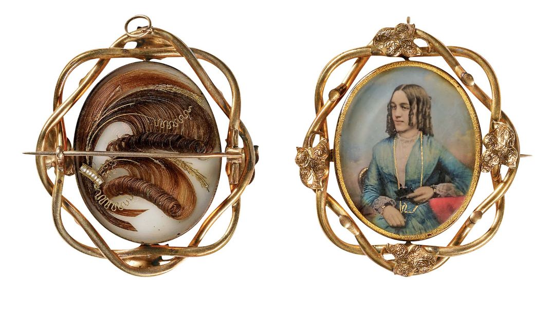 a case that functions as a pin or pendant holds a daguerreotype