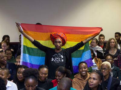 An activist holds up a rainbow flag inside Botswana's High Court to celebrate Tuesday's landmark ruling.