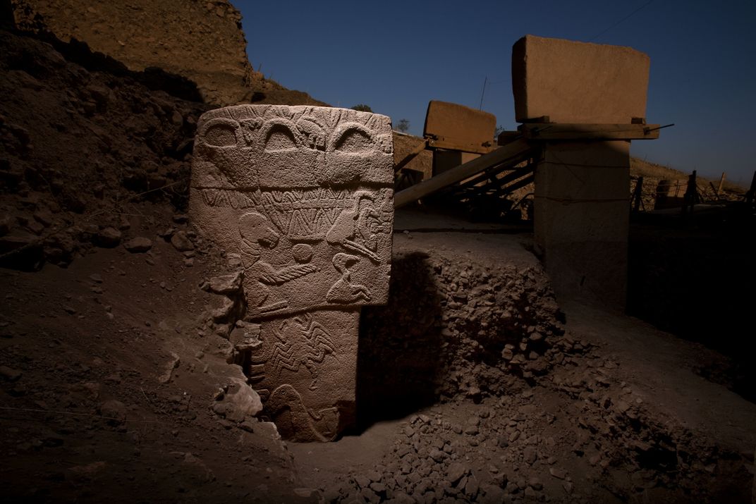 'a stone pillar with carvings on it'