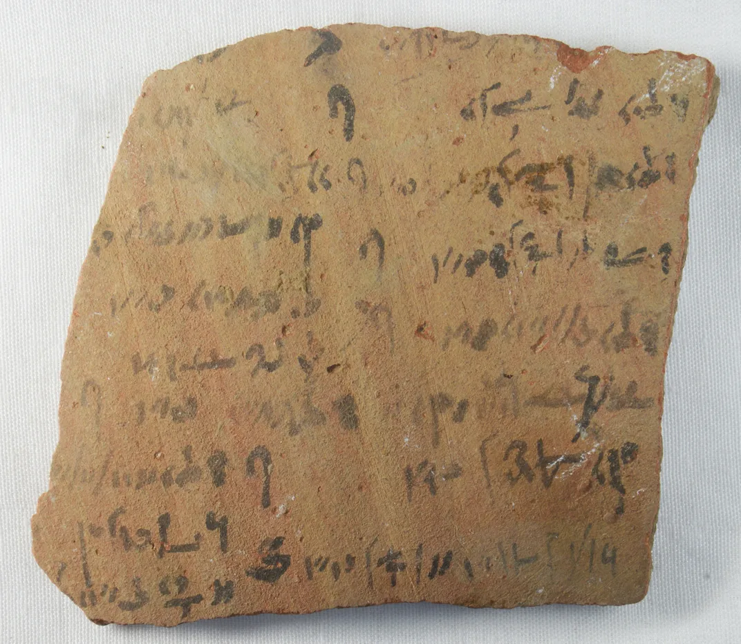 brown square fragment with worn black writing