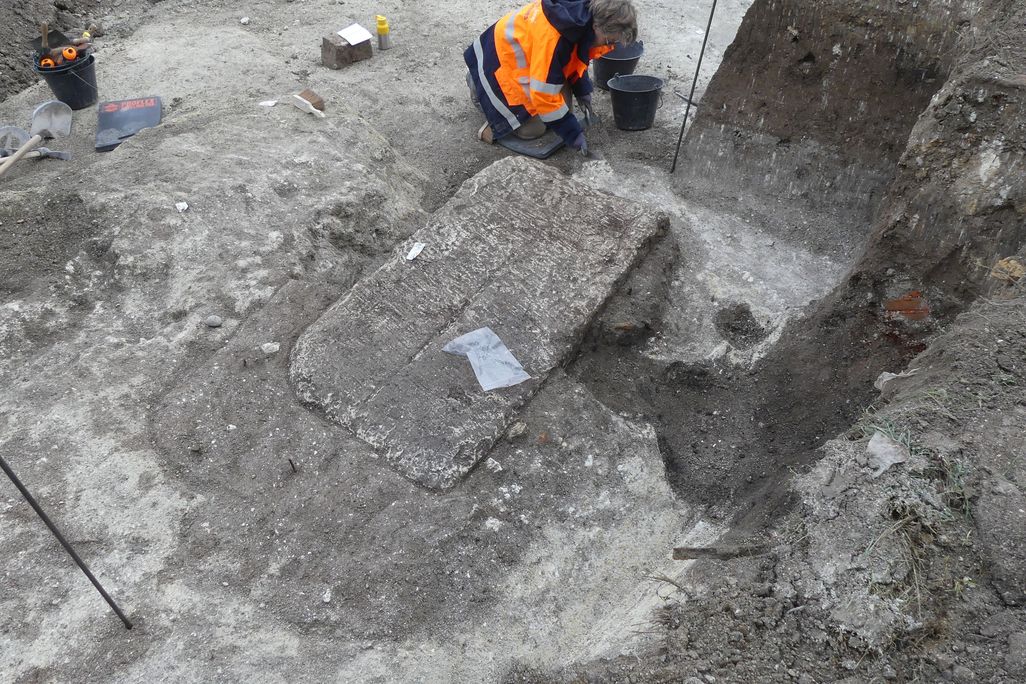 Limestone sarcophagus being excavated