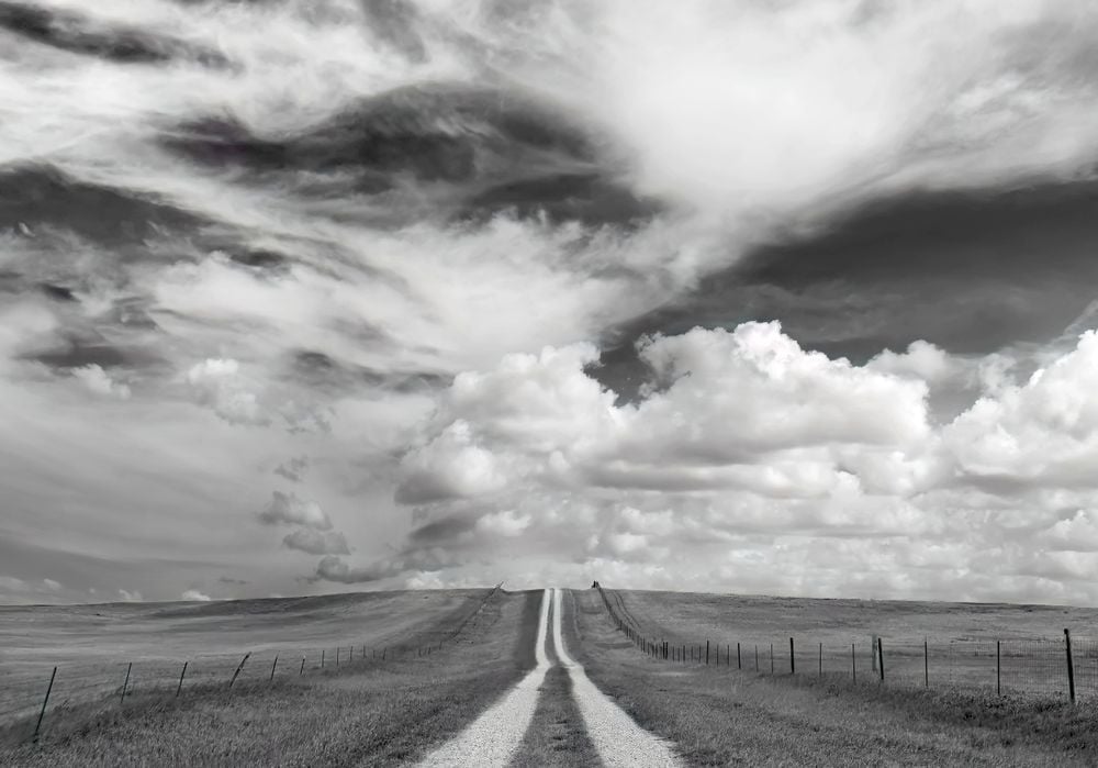 Clouds over a gravel road in central South Dakota. The Midwest and Great Plains are often considered tedious to travel through. Not for me. Instead of looking down from a jet, I choose to drive, looking up.