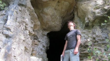 The author stands at the entrance to the hilltop cave near Saint Julien de Lampon, that served in the 1940s as a wartime refuge from Nazis.