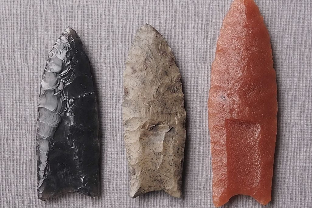 Overhead shot of three small pointed weapons made of rock