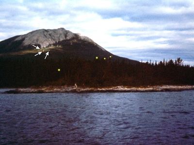 Earthquake lights seen Tagish Lake, in the Yukon Territory, in 1972. Large orbs are visible in the foreground, while smaller ones (highlighted by arrows) are seen higher up.