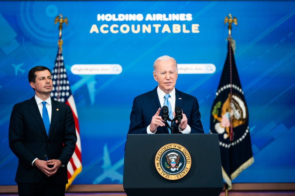Transportation Secretary Pete Buttigieg listens as President Joe Biden delivers remarks