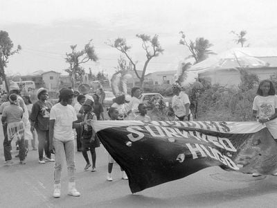 Young people of the U.S. Virgin Islands march along in a carnival parade, amid the destruction of Hurricane Hugo in 1989.
