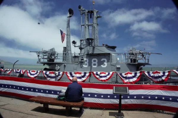 Man sits after Submarine ceremony, honoring seamen lost at sea.  Camera: Sony A6000. thumbnail