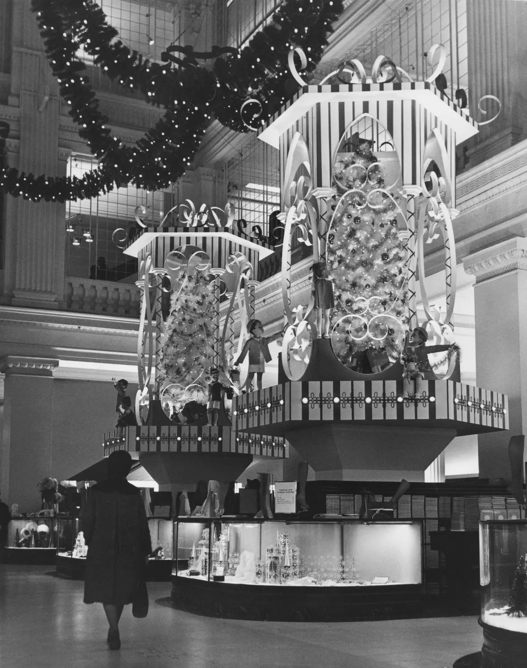 A woman strolls through a holiday shopping display at the Marshall Field's department store in Chicago, circa 1960s
