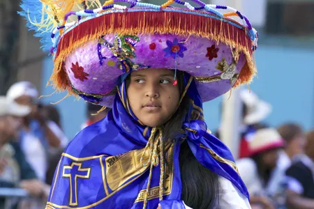 Colorful beads, tassels and fabrics help a partygoer dress the part to celebrate New York City&rsquo;s Hispanic Day Parade.