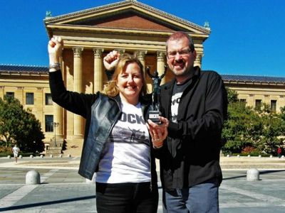 Larissa and Michael Milne, shown here in their hometown of Philadelphia, sold nearly all their belongings in 2011 and embarked on a tour of the world. Along the way they visited the frightening but fascinating country of North Korea. Also shown in this photo is the Milnes’ travel companion, “Little Rocky,” a six-inch figurine of one of Philadelphia’s most famous native sons.